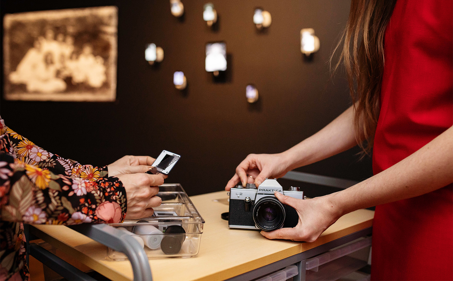 Two hands holding photography tools.