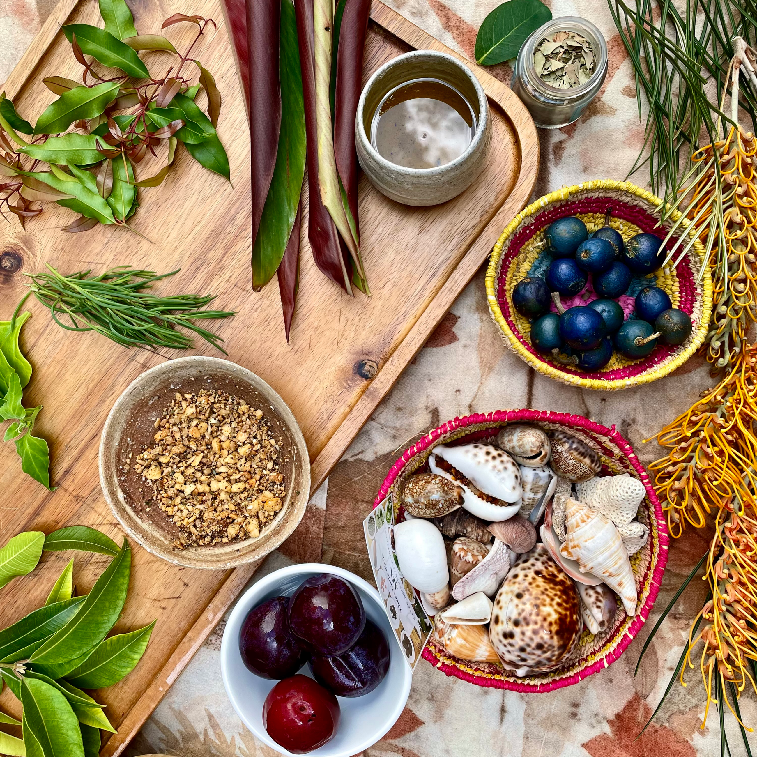 An arial image of beautiful, fresh ingredients such as leaves, nuts, berries and other natural products like shells and flowers.